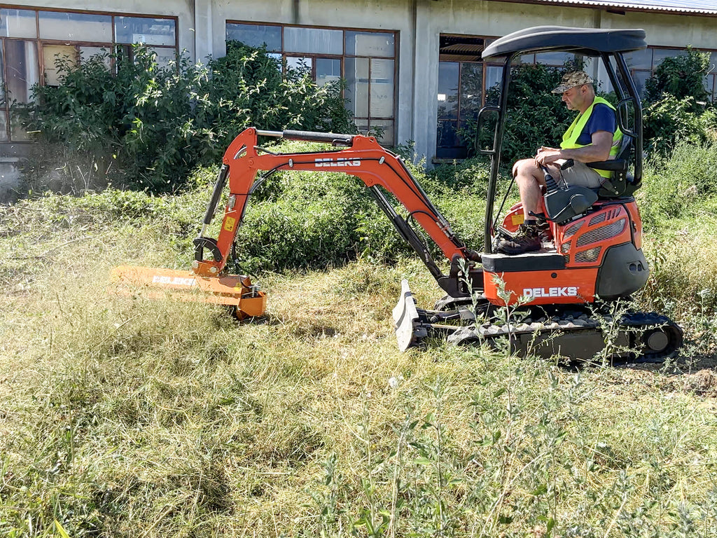 Mini excavator mulching grass with the DELEKS AR forestry mulcher
