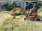 Mini excavator mulching grass with the DELEKS AR forestry mulcher