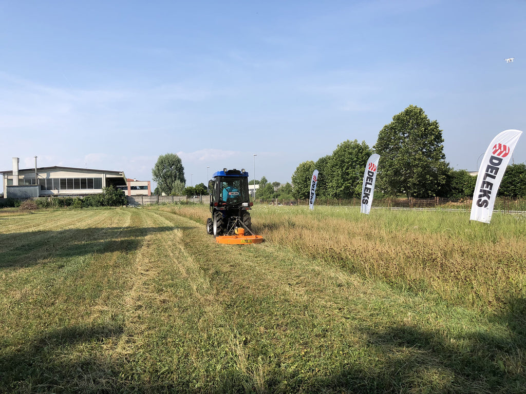 DELEKS BUGGY rotary cutter mowing grass at a field demonstration