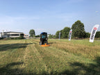 DELEKS BUGGY rotary cutter mowing grass at a field demonstration
