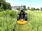 Compact tractor cutting tall grass with the DELEKS BUGGY