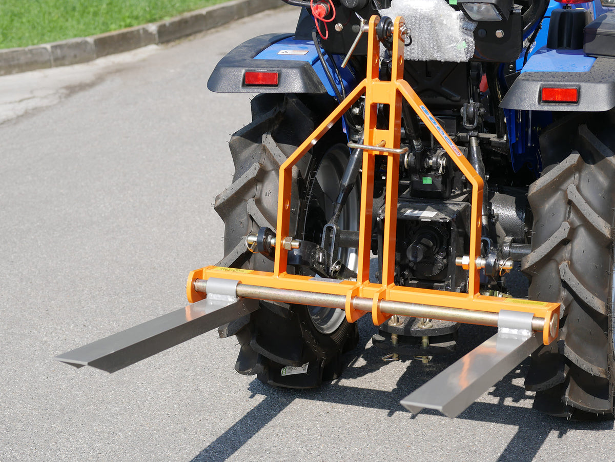 DELEKS D-300 pallet forks mounted on the rear of a compact tractor