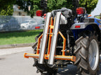 Compact tractor with DELEKS D-300 pallet forks raised, side view