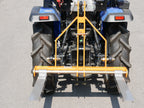 Rear view of a compact tractor with DELEKS D-300 pallet forks