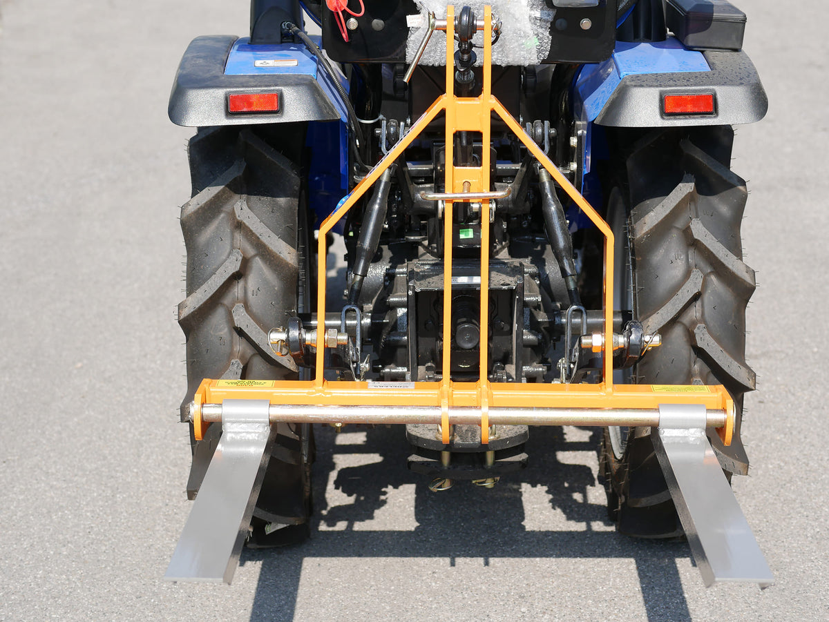 Rear view of a compact tractor with DELEKS D-300 pallet forks