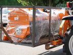 Compact tractor carrying a crate with DELEKS D-300 forks, side view