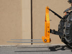 Tractor with DELEKS D-700 pallet forks lowered, side view
