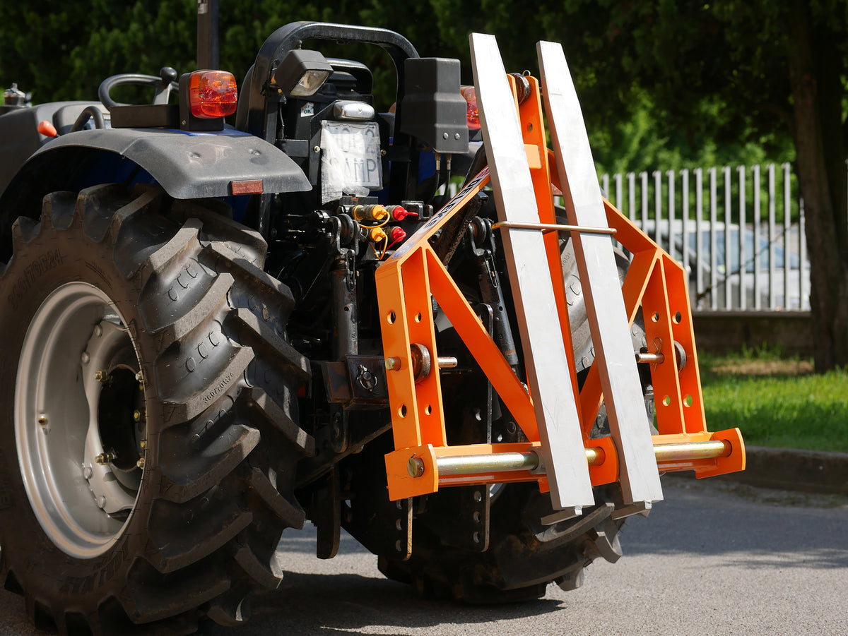DELEKS D-700 pallet forks mounted on a tractor with tines folded up