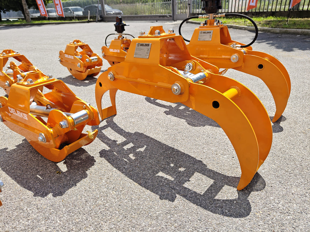 DELEKS DK10H log grapples lined up outside the factory