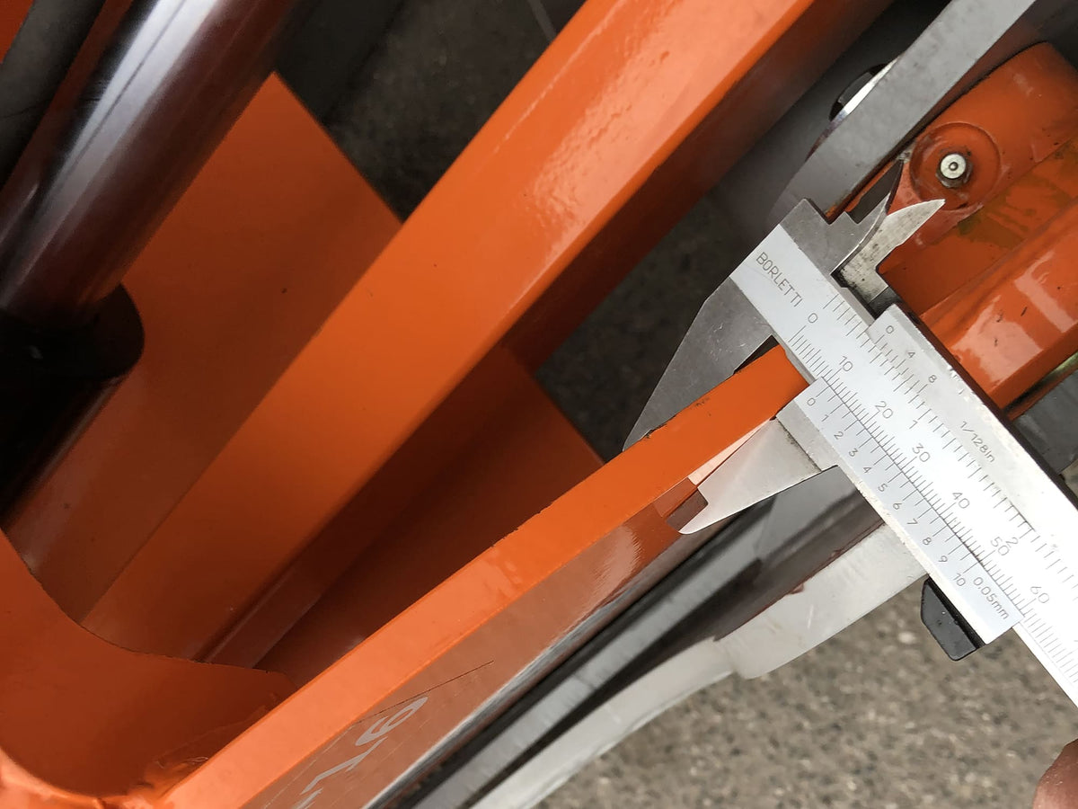Caliper measuring the tine thickness of the DELEKS DK16 grapple