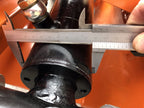 Caliper measuring the pin diameter of the DELEKS DK16 grapple