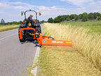 Tractor mowing a roadside verge with the DELEKS GIRAFFA offset flail mower