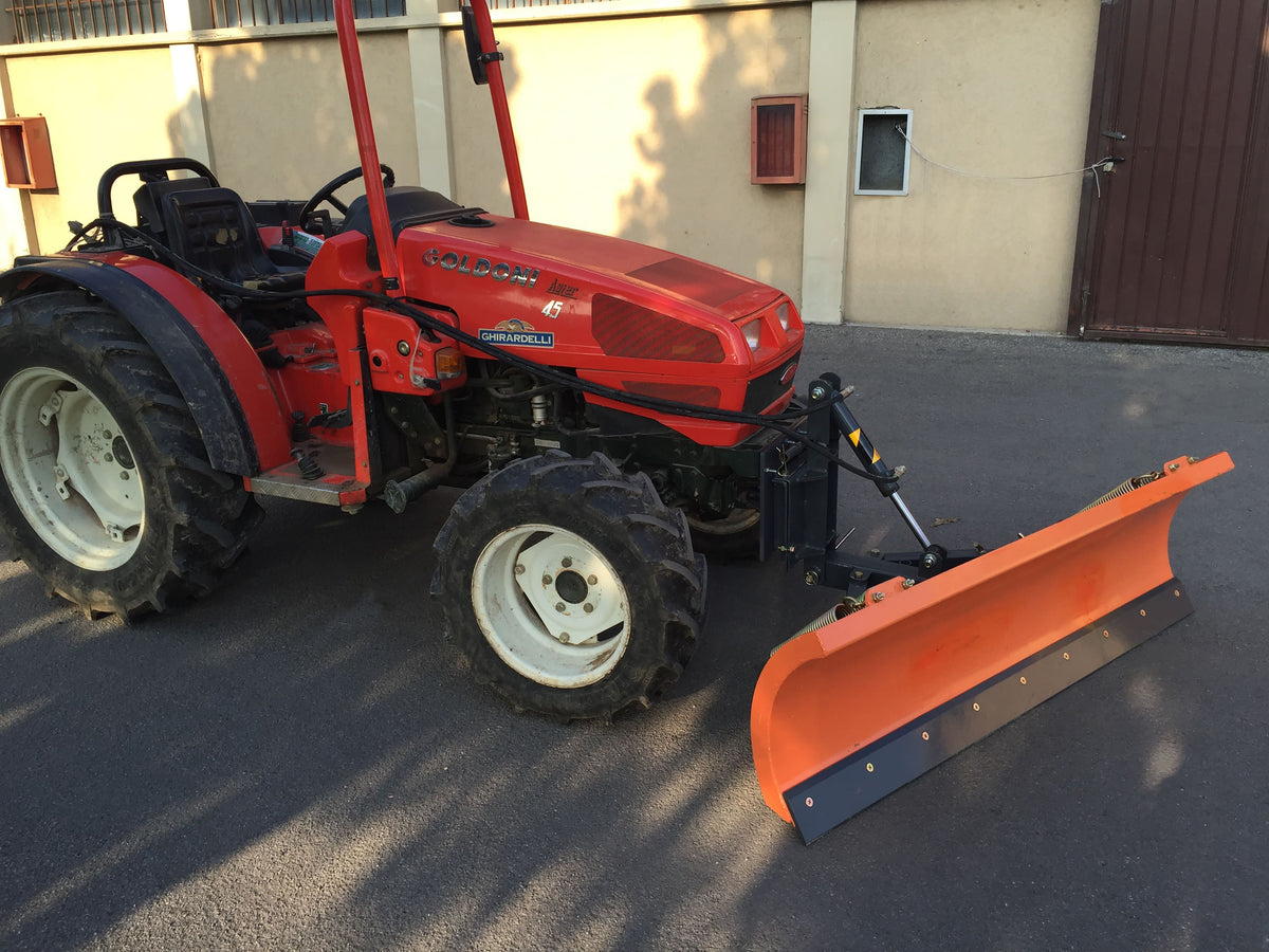 DELEKS LNS snow plow angled on a compact tractor