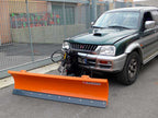 DELEKS LNS-J snow plow mounted on a 4x4 pickup, front three-quarter view