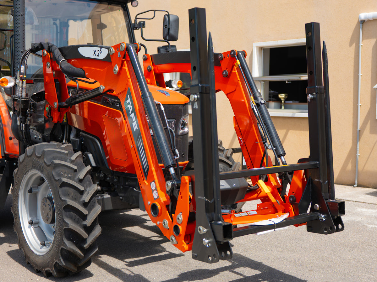 DELEKS DK1T bale fork mounted on a Kubota front loader, side view