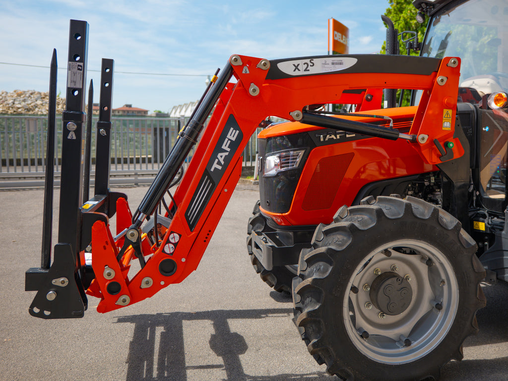 DELEKS DK1T bale fork raised on a tractor front loader